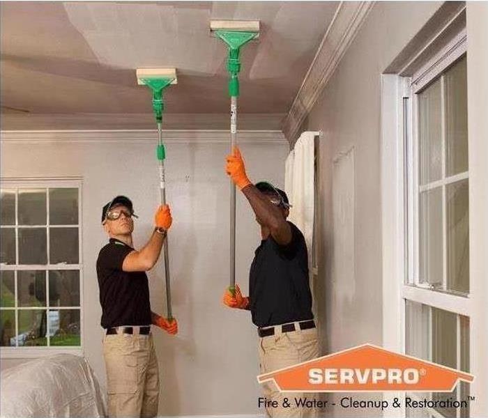 SERVPRO technicians cleaning ceiling